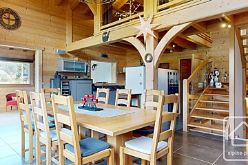 A wooden house with a clock that says alpine on it