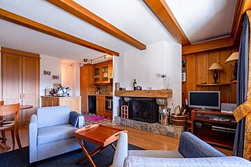 A living room with a fireplace and a flat screen tv