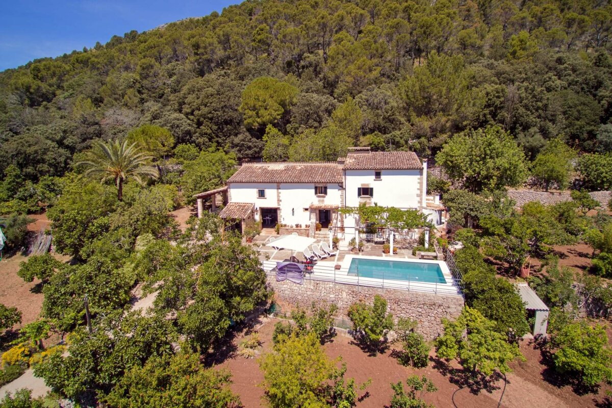 An aerial view of a house with a swimming pool
