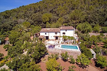 An aerial view of a house with a swimming pool