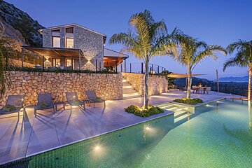 A house with a swimming pool in front of it