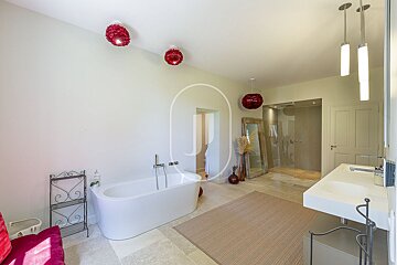 A bathroom with a bathtub and two sinks