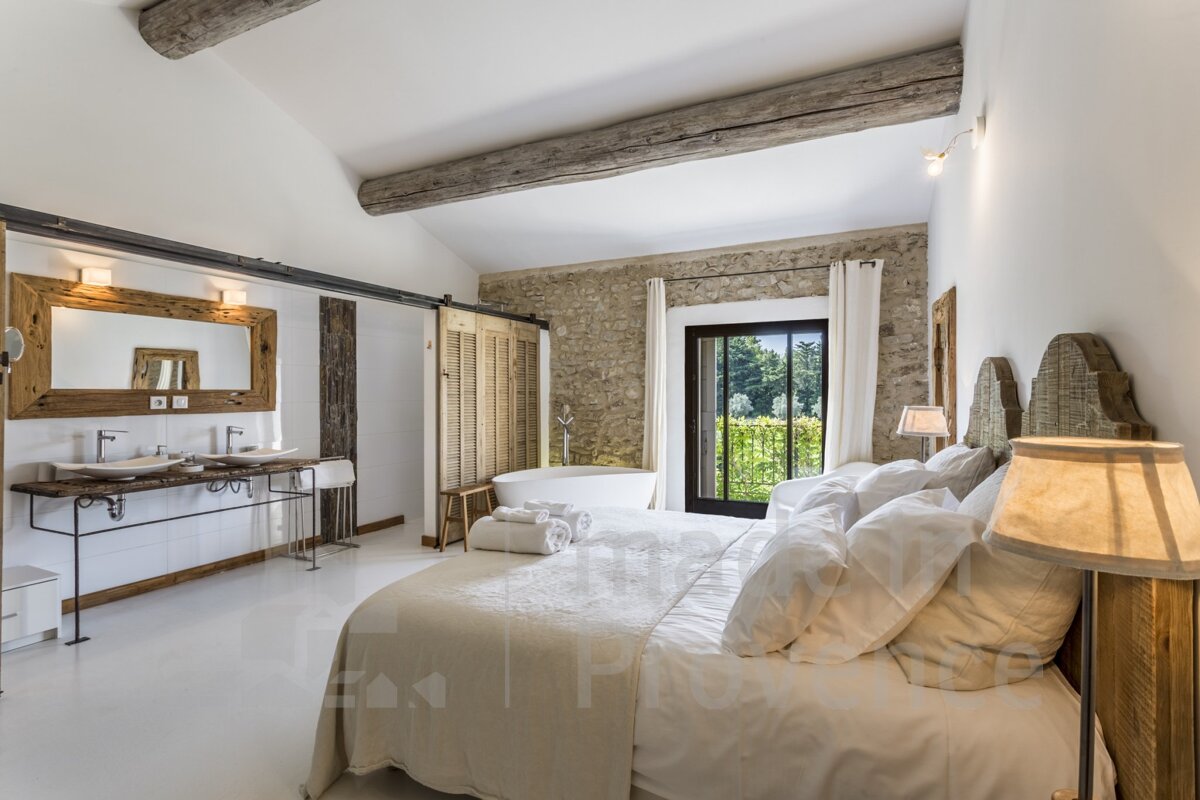 A bedroom with a king size bed and a bathtub