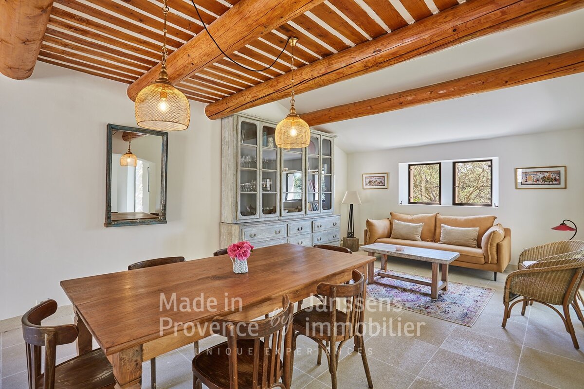 A living room with a table and chairs and the words made in provence on the wall