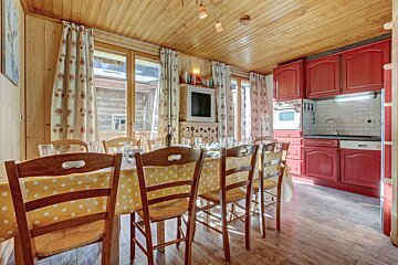 A kitchen with red cabinets and a yellow table cloth