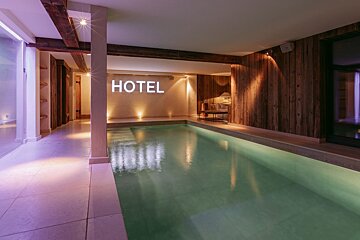 A swimming pool with the word hotel on the wall