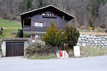 A house with a garage and a fire hydrant in front of it