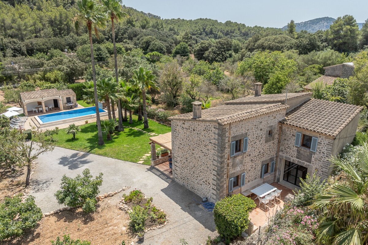 An aerial view of a house with a swimming pool