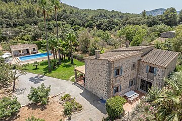 An aerial view of a house with a swimming pool