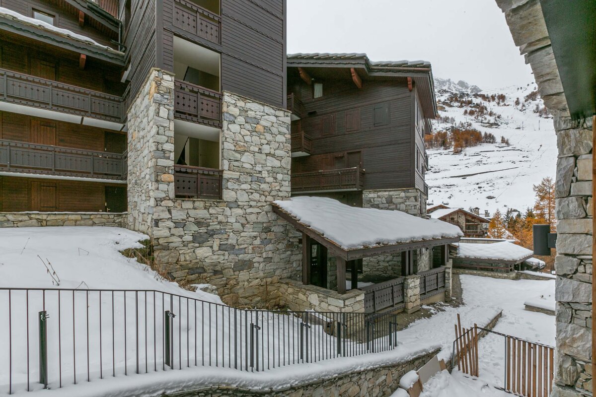 A snowy building with a fence in front of it