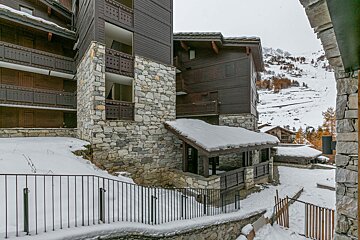 A snowy building with a fence in front of it