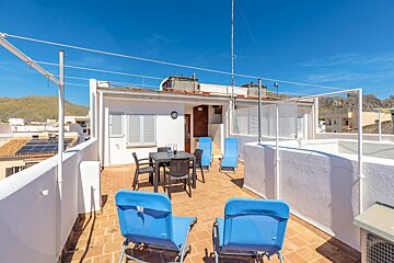 A balcony with a table and chairs on it