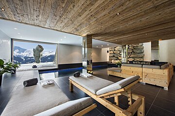 A large room with a swimming pool and chairs