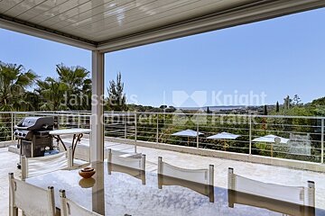 A patio with a table and chairs and a knight logo