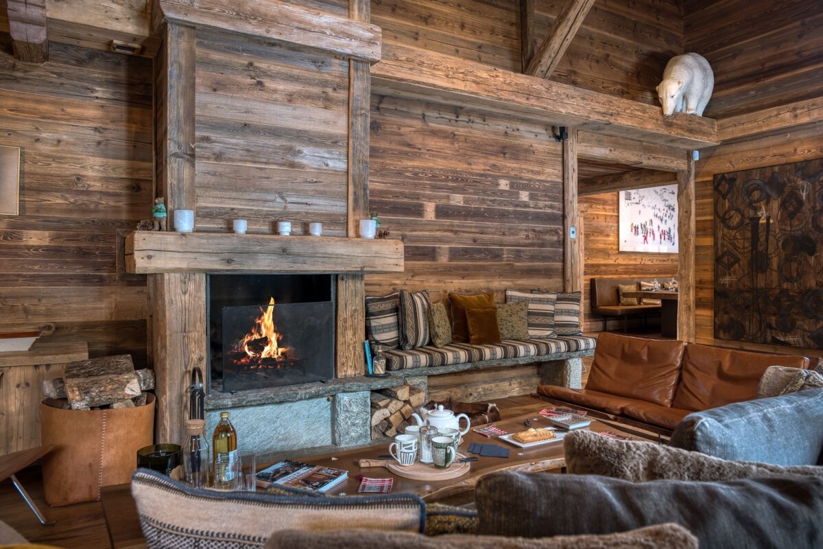 A living room with a fireplace and a polar bear on the ceiling