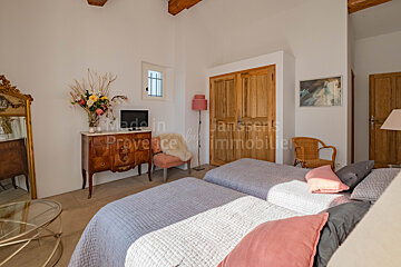A bedroom with two beds and a dresser that says made in provence