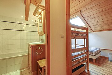 A bathroom with a bunk bed and a sink