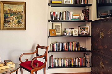 A bookshelf filled with books including one titled ' a brief history of the world '
