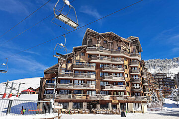 A ski lift is going up to the top of a building