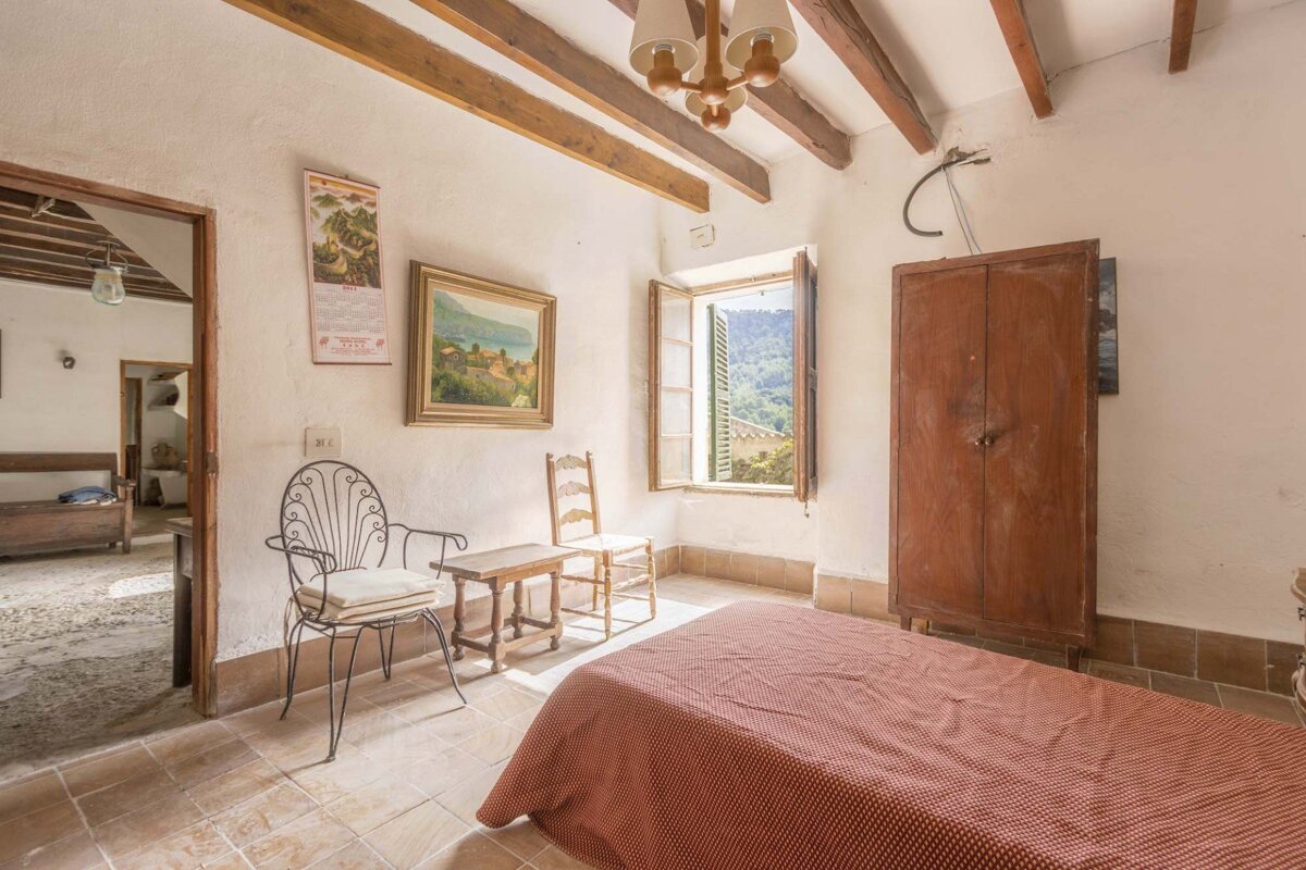 A bedroom with a painting on the wall that says 