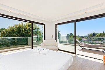 A bedroom with sliding glass doors and a hammock