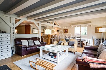 A living room with a brown couch and a white coffee table
