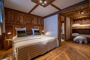 A bedroom with a bunk bed and a statue of a polar bear