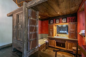 A bathroom with wooden cabinets and a bathtub