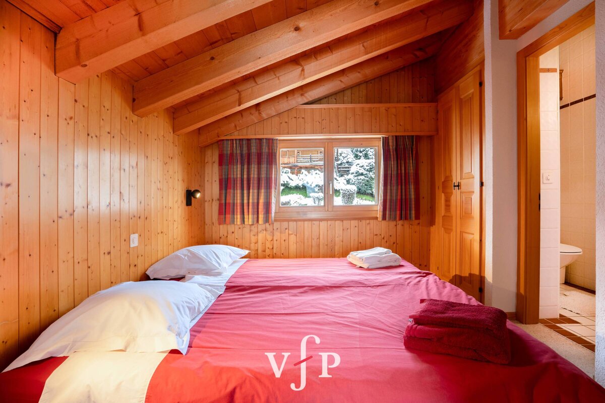 A bedroom with a bed and a window with the letters vfp on it