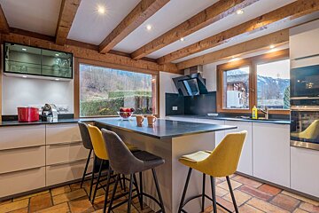 A kitchen with a large island and stools