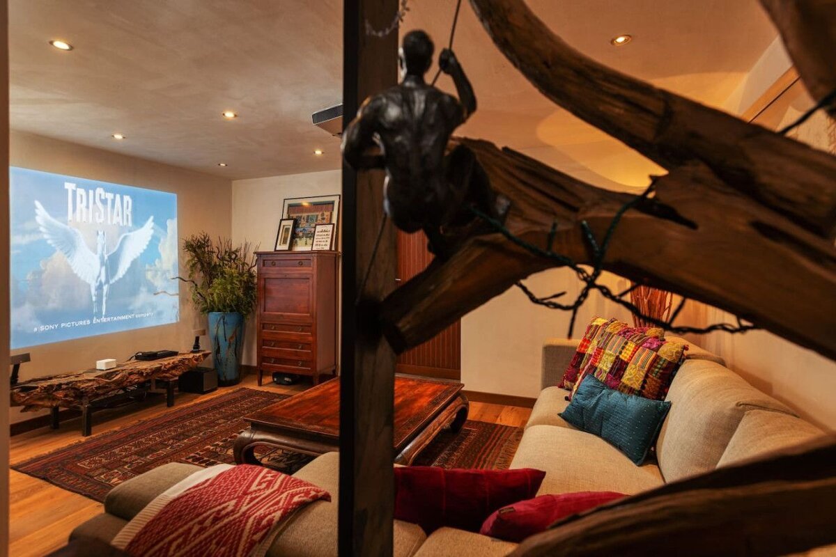 A living room with a projector screen that says tristan