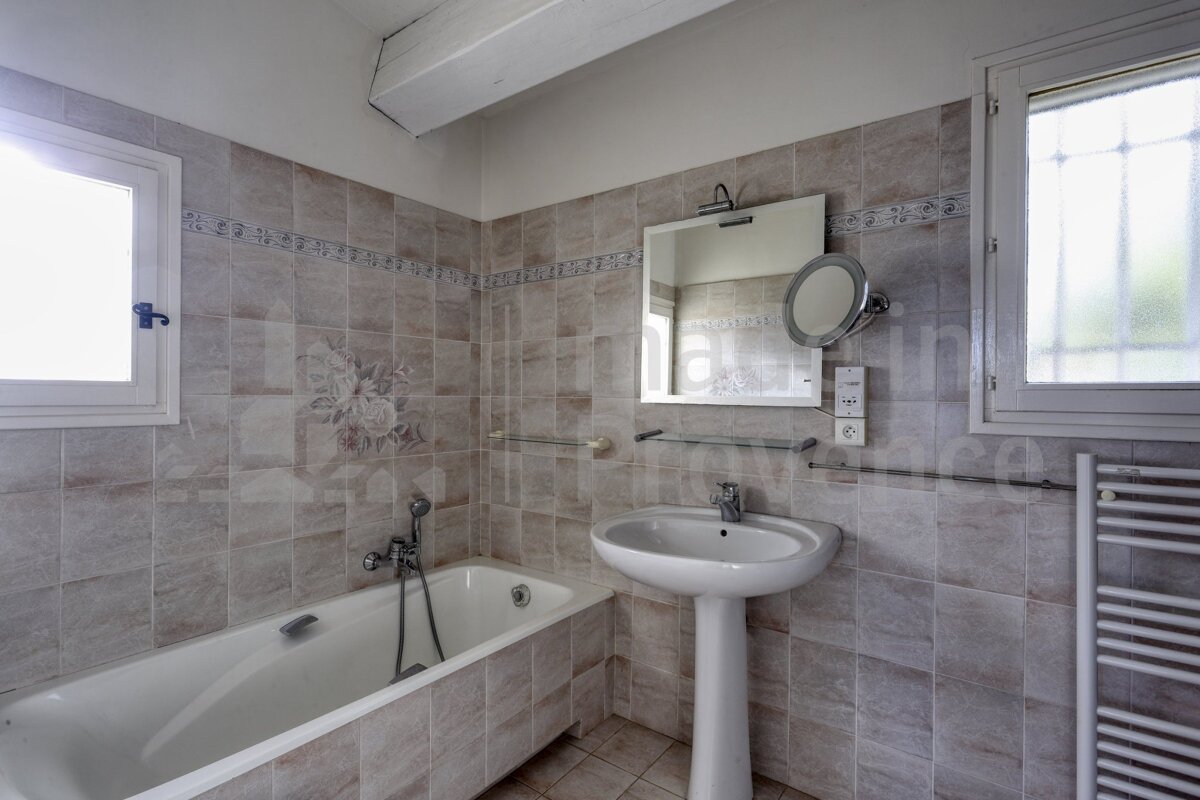 A bathroom with a bathtub a sink and a mirror