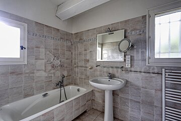A bathroom with a bathtub a sink and a mirror