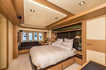 A bedroom with a bed and pillows that say 