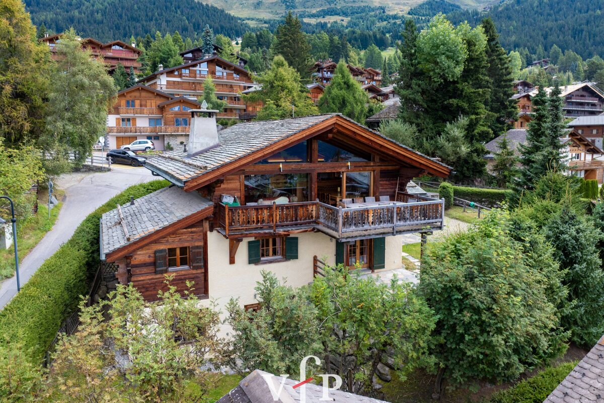 An aerial view of a house in the mountains with the letters vip on the roof