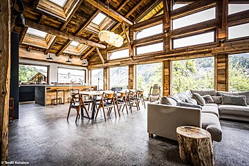 A living room with a lot of windows and a couch