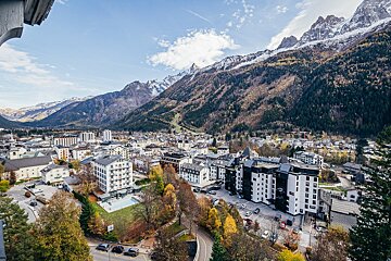 An aerial view of a city with mountains in the background