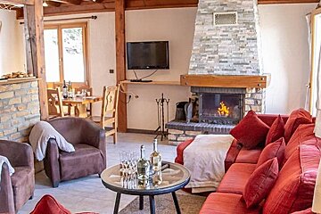 A living room with a fireplace and a flat screen tv