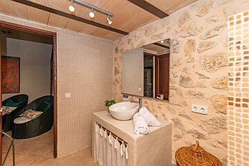 A bathroom with a sink and a large mirror