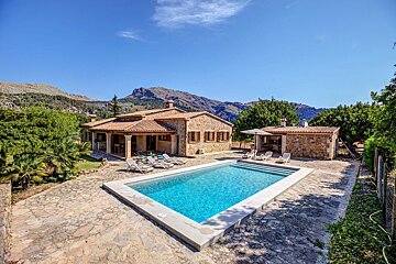 A house with a large swimming pool in front of it