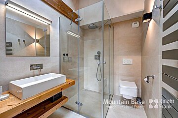 A bathroom with a knight frank logo on the wall