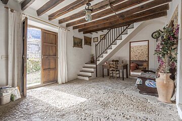 A room with stairs leading up to the second floor