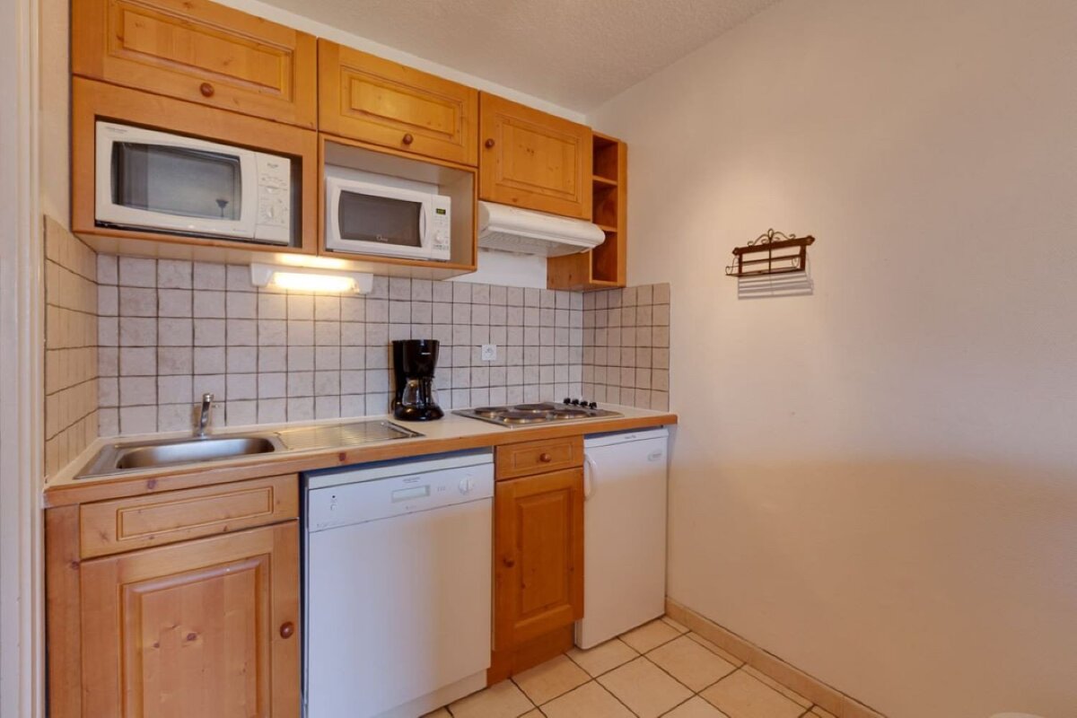 A small kitchen with a microwave and a coffee maker
