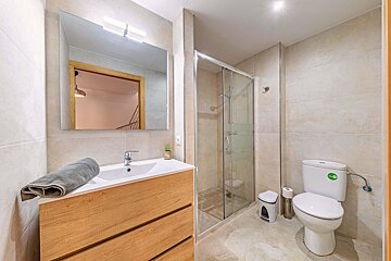 A bathroom with a toilet a sink and a mirror