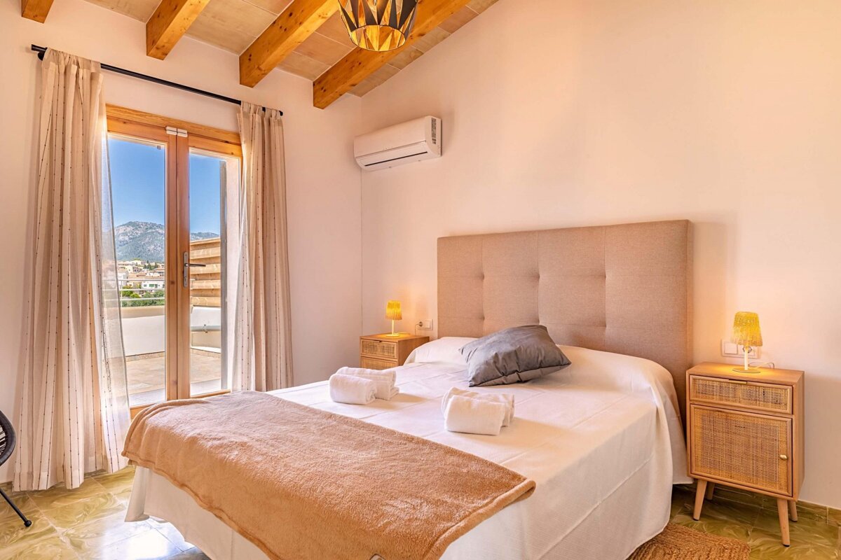 A bedroom with a large bed and two nightstands