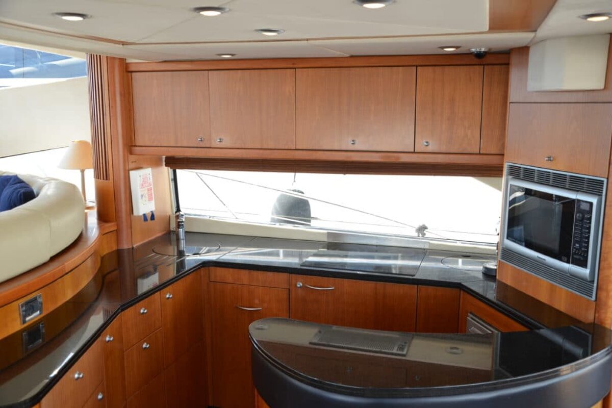 A kitchen on a boat with a microwave and a sink