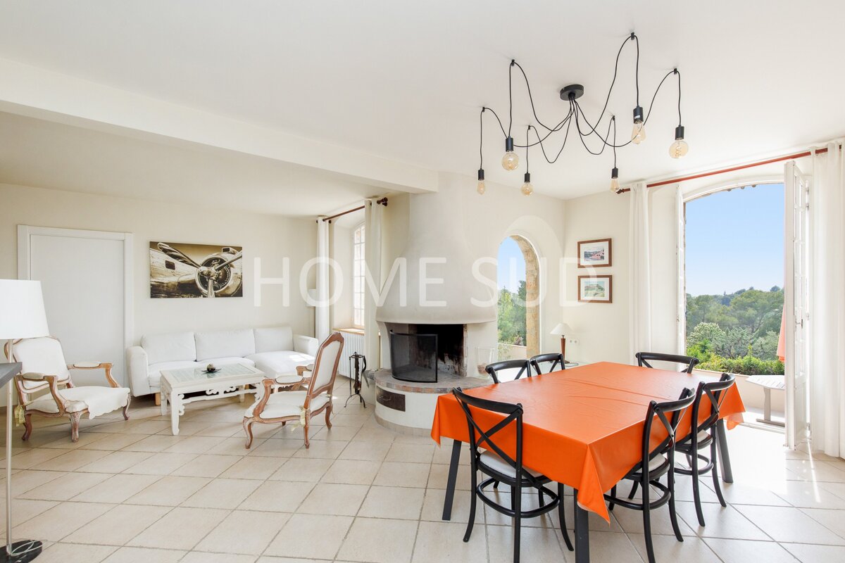 A living room with a fireplace and a table that says home sue