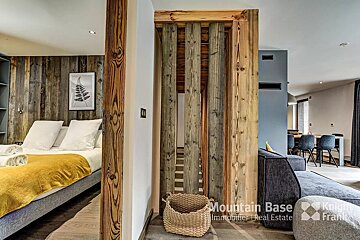 A room with a bed and a couch and a sign that says mountain base