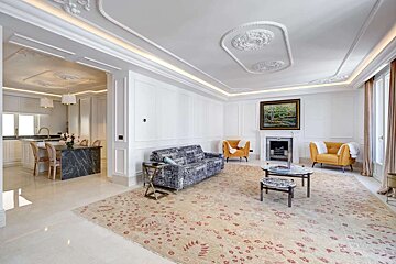 A living room with a couch and chairs and a fireplace