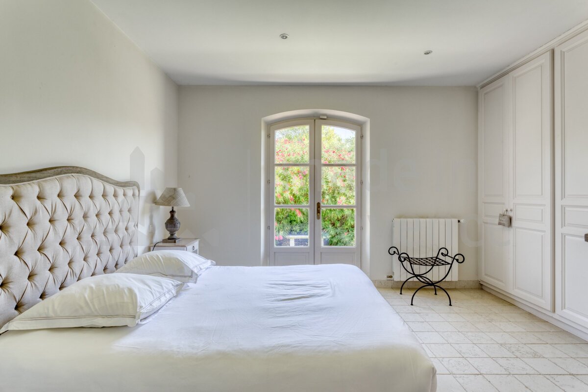 A bedroom with a bed a lamp and a radiator